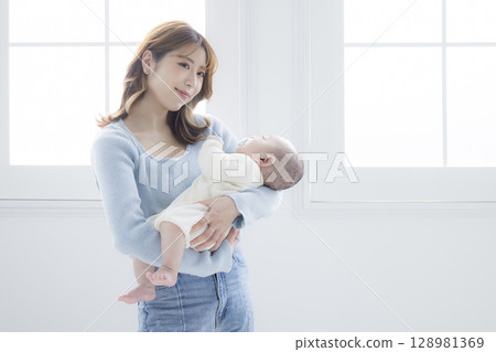 媽媽抱著一個嬰兒 媽媽抱著一個嬰兒 128981369