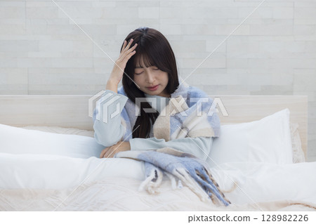 Tired woman in bed 128982226