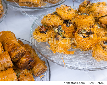 Assorted middle eastern pastries with baklava and kataifi on display 128982682