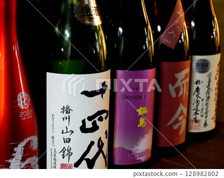 Bottles displayed on a shelf Bottles displayed on a shelf 128982802