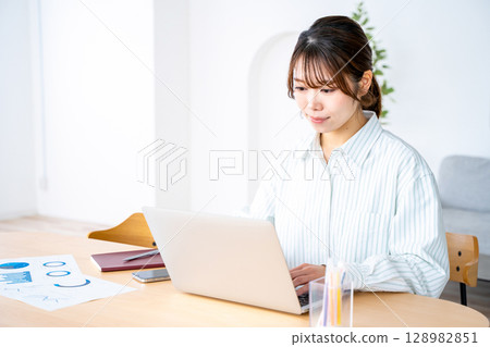 Young woman working remotely Young woman working remotely 128982851