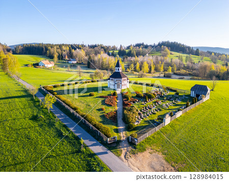 This aerial perspective showcases the picturesque Tesarov Chapel, an octagonal structure nestled in Korenov, surrounded by lush greenery and scenic landscapes in the Jizera Mountains. This aerial perspective showcases the picturesque Tesarov Chapel, an octagonal structure nestled in Korenov, surrounded by lush greenery and scenic landscapes in the Jizera Mountains. 128984015