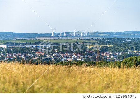 Hradek nad Nisou showcases a picturesque backdrop with the Turow Coal Mine visible in the distance. The blend of urban and industrial elements highlights the region's character. Hradek nad Nisou showcases a picturesque backdrop with the Turow Coal Mine visible in the distance. The blend of urban and industrial elements highlights the region's character. 128984073