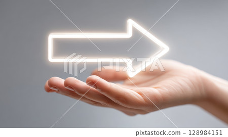 Hand holding glowing arrow symbolizing business growth and success with financial chart increase trend and marketing strategy for economic 128984151