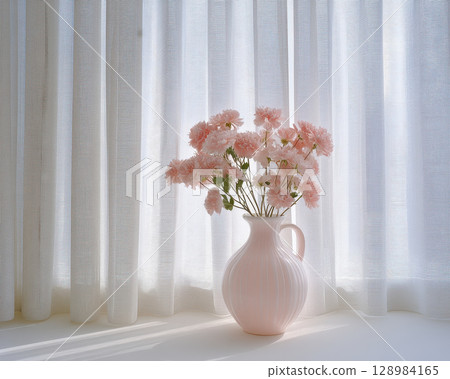 Soft pink flower bouquet in ceramic vase with backlit white curtains creating gentle and peaceful home atmosphere 128984165