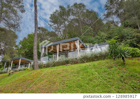 Luxury mobile homes on terraced forest hillside 128985917