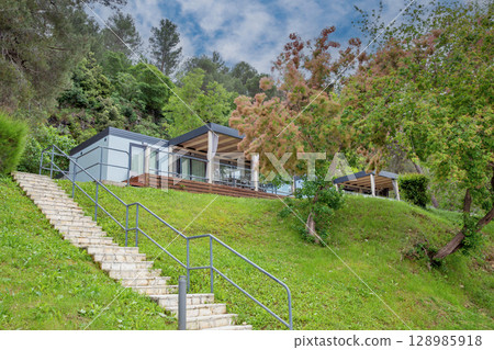 Premium mobile home with glass terrace in forest. 128985918