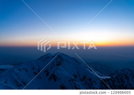 Sunset over Mount Okudainichi in Tateyama (blue hour view from Tsurugi-Gozen) Climbing Mount Tateyama and Mount Betsuyama in the Northern Alps during the remaining snow season 128986005