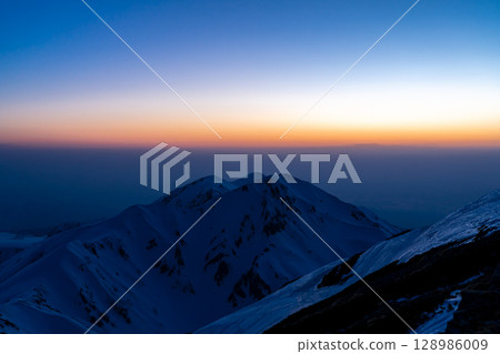 Sunset over Mount Okudainichi in Tateyama (blue hour view from Tsurugi-Gozen) Climbing Mount Tateyama and Mount Betsuyama in the Northern Alps during the remaining snow season Sunset over Mount Okudainichi in Tateyama (blue hour view from Tsurugi-Gozen) Climbing Mount Tateyama and Mount Betsuyama in the Northern Alps during the remaining snow season 128986009