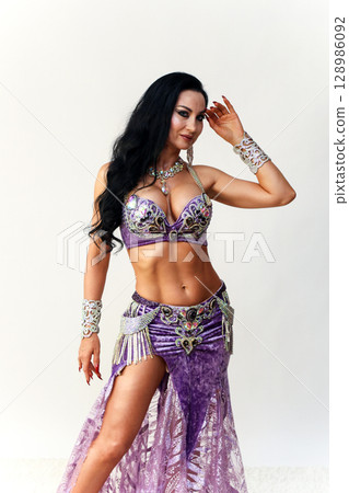 Elegant Brunette Dancer in Traditional Eastern Dance Costume Showcasing Grace and Beauty Elegant Brunette Dancer in Traditional Eastern Dance Costume Showcasing Grace and Beauty 128986092