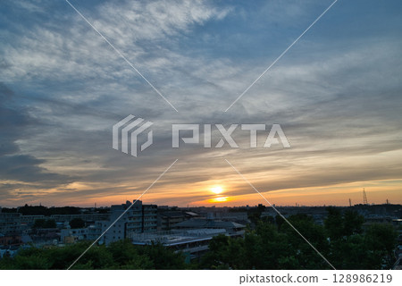 Sunrise over the residential area, sunrise, morning over the residential area, early morning, morning glow, morning sun, sun 128986219
