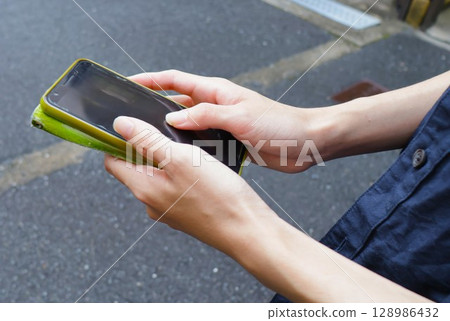 The fingers of a young man touching a smartphone, student in his 20s 2 The fingers of a young man touching a smartphone, student in his 20s 2 128986432
