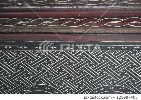 Old wood wall with traditional paint pattern 128987405
