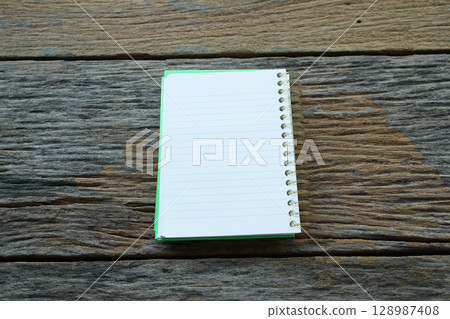 opened notebook on old rustic grunge wood table 128987408