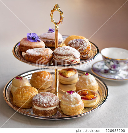 Elegant Pastries and Tea Time Delight 128988200