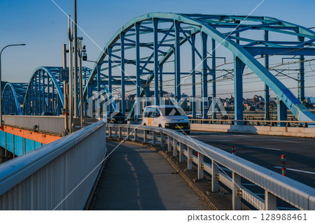 Cars Running on the Dongjak Bridge on the Han River in Seoul, Korea, filmed in the late afternoon of summer 128988461