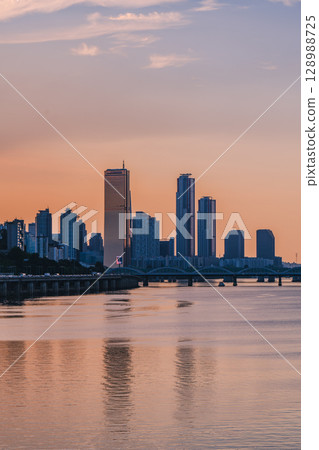 Yeouido, the financial district of Seoul, Korea, and the surrounding city scenery taken during the summer sunset Yeouido, the financial district of Seoul, Korea, and the surrounding city scenery taken during the summer sunset 128988725