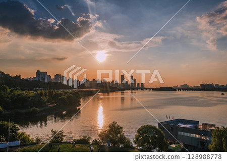 Yeouido, the financial district of Seoul, Korea, and the surrounding city scenery taken during the summer sunset Yeouido, the financial district of Seoul, Korea, and the surrounding city scenery taken during the summer sunset 128988778