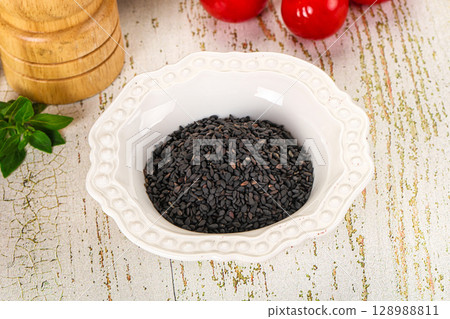 Black sesame seeds in the bowl Black sesame seeds in the bowl 128988811