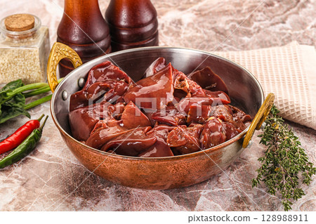 Raw uncokked chicken liver in the bowl 128988911