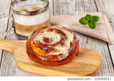 Glazed cinnabon swirl with icing Glazed cinnabon swirl with icing 128988931