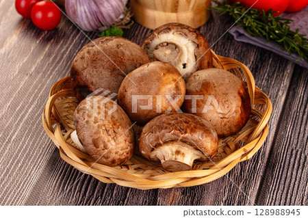 Raw brown champignon heap for cooking Raw brown champignon heap for cooking 128988945