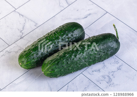 Ripe green raw two cucumbers 128988966