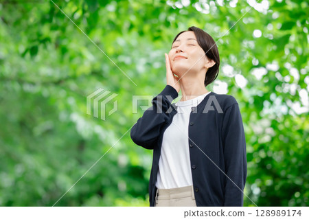 A woman standing in fresh green 128989174