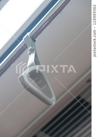 Hand grip inside the train of SRT Dark Red Line. It is a rapid transit line operated as part of the MBTA subway system from Bangkok to Rangsit 128989362