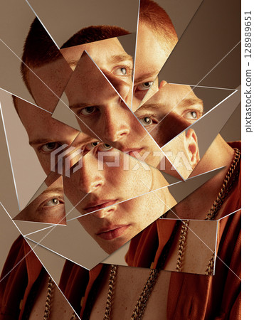 Bold artwork of young man face reflected in shattered mirror pieces with intense expression Bold artwork of young man face reflected in shattered mirror pieces with intense expression 128989651
