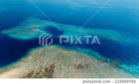 Seascape view over coral reef with blue ocean, aerial drone Seascape view over coral reef with blue ocean, aerial drone 128989788