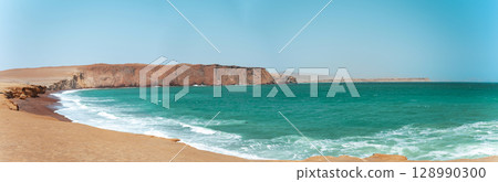A beautiful beach with a rocky cliff in the background. Panoramic view Paracas, Peru A beautiful beach with a rocky cliff in the background. Panoramic view Paracas, Peru 128990300