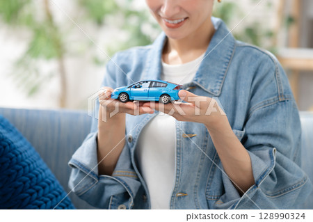 A woman holding a car A woman holding a car 128990324
