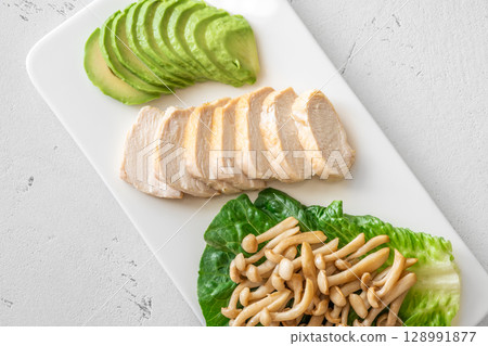 Avocado, mushrooms, and chicken presented as fresh minimalist healthy lifestyle plate Avocado, mushrooms, and chicken presented as fresh minimalist healthy lifestyle plate 128991877
