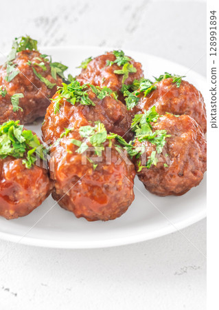 Juicy Spanish Albondigas Served in Tomato Sauce with Fresh Parsley on Top 128991894
