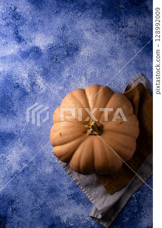 Raw fresh cut pumpkin on dark background 128992009