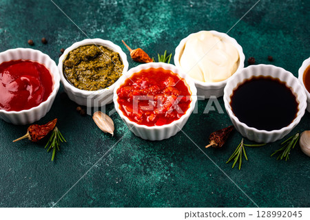 Set of different sauces. Ketchup, mustard, pesto Set of different sauces. Ketchup, mustard, pesto 128992045