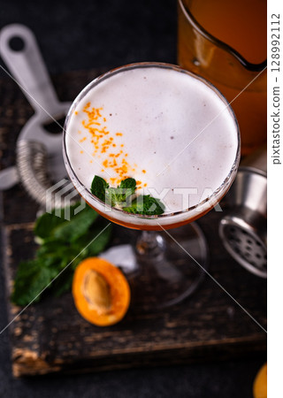 Fresh apricot cocktail martini with mint 128992112