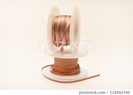 Copper braid for cleaning printed circuit boards from solder. Copper coils with braid. A tool for removing solder from printed circuit boards. Copper braid for cleaning printed circuit boards from solder. Copper coils with braid. A tool for removing solder from printed circuit boards. 128992540