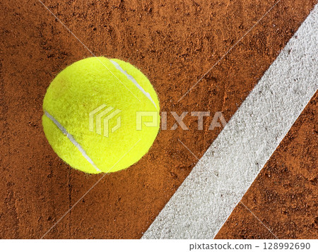 Freeze Motion Detail Shot of Tennis Ball Hitting a Clay Court Freeze Motion Detail Shot of Tennis Ball Hitting a Clay Court 128992690
