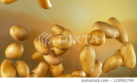 Freeze motion of flying early potatoes , Close-up Freeze motion of flying early potatoes , Close-up 128992749