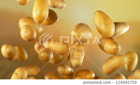 Freeze motion of flying early potatoes , Close-up 128992750