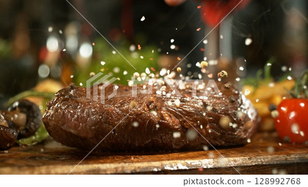 Delicious beef steak on wooden table, close-up 128992768