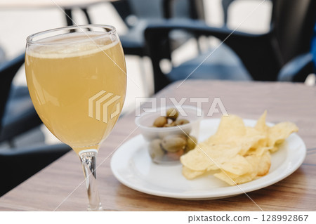 spanish appetizer: shandy, potato chips and olives spanish appetizer: shandy, potato chips and olives 128992867