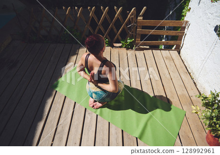 Peaceful Woman Practicing Yoga Outdoors on Green Mat During Daytime Peaceful Woman Practicing Yoga Outdoors on Green Mat During Daytime 128992961