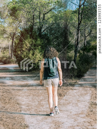 Woman choosing a path in a forest. Concept of decision making in life. 128993555
