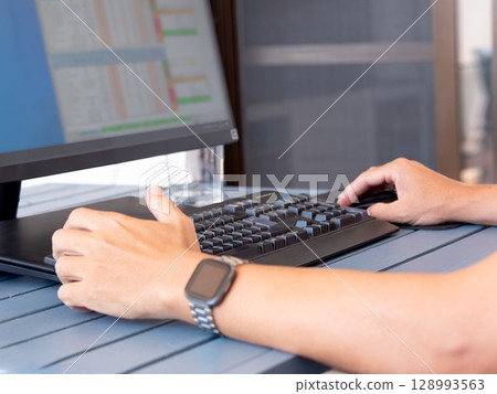 Remote work setup with casual attire and modern desk accessories 128993563