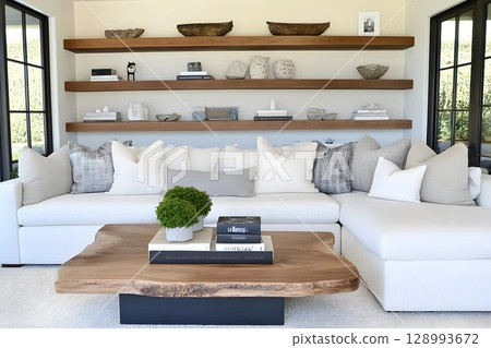 Modern minimalist living room interior with white sectional sofa and floating shelves 128993672