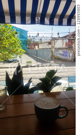 Latte Art and Urban Street View from a Cafe Window Latte Art and Urban Street View from a Cafe Window 128993803
