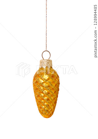 A Christmas decorative tree ornament in the shape of a golden pine cone on a string, isolated on a white background with clipping path. Design element for Christmas card 128994485
